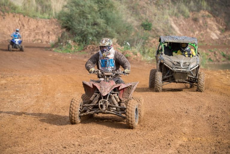 A person riding an ATV on a trail, highlighting the importance of having ATV insurance for protection and peace of mind.