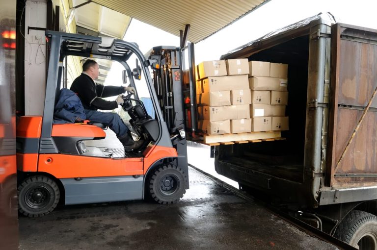 Shipping containers being loaded onto a cargo ship, representing the security and protection provided by Cargo Insurance