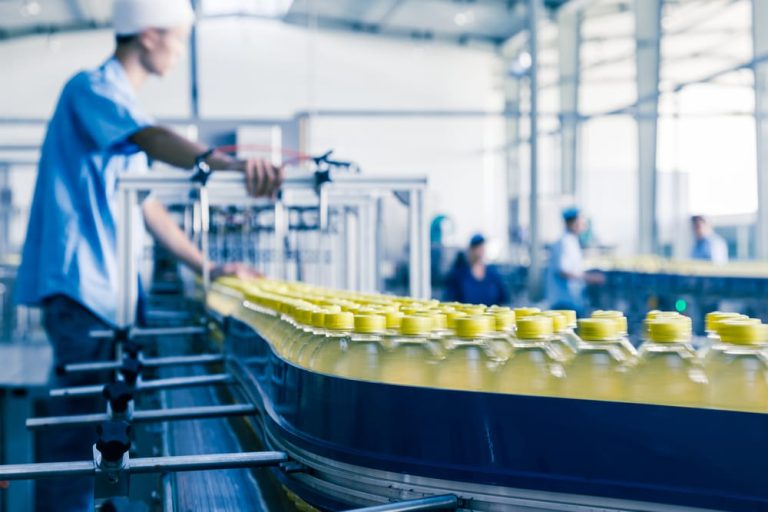 An image of a worker in a warehouse or manufacturing environment, inspecting products with care. Nearby, a document or symbol representing insurance coverage is visible, highlighting the importance of product liability insurance in protecting both the business and its customers