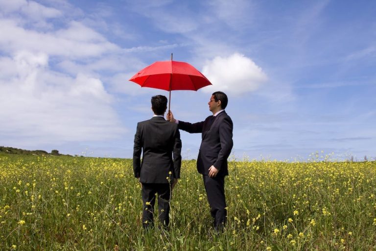 An open umbrella shielding an individual, symbolizing the added protection of personal umbrella insurance