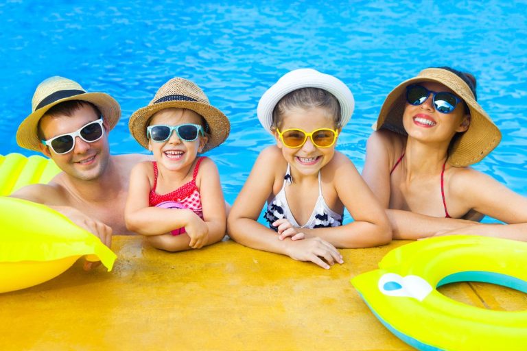 Family enjoying summer activities together, including swimming and picnicking, with tips for staying cool and refreshed in the heat.