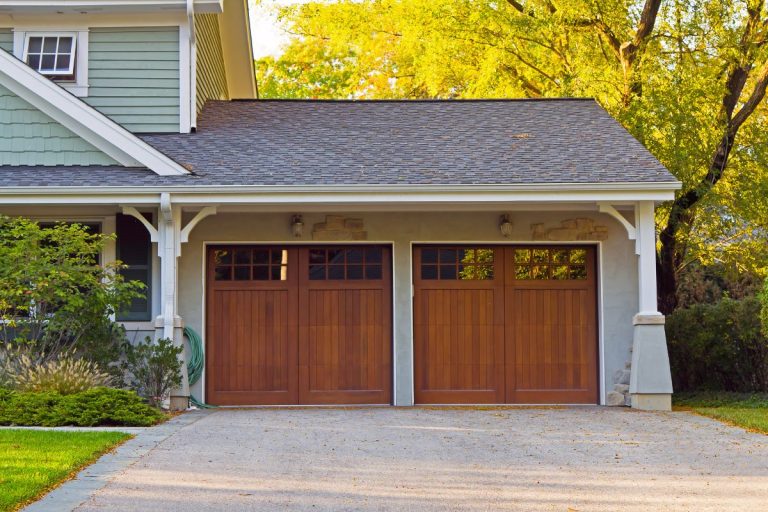 A spacious garage with proper fall maintenance, including organized shelves and seasonal items stored away neatly