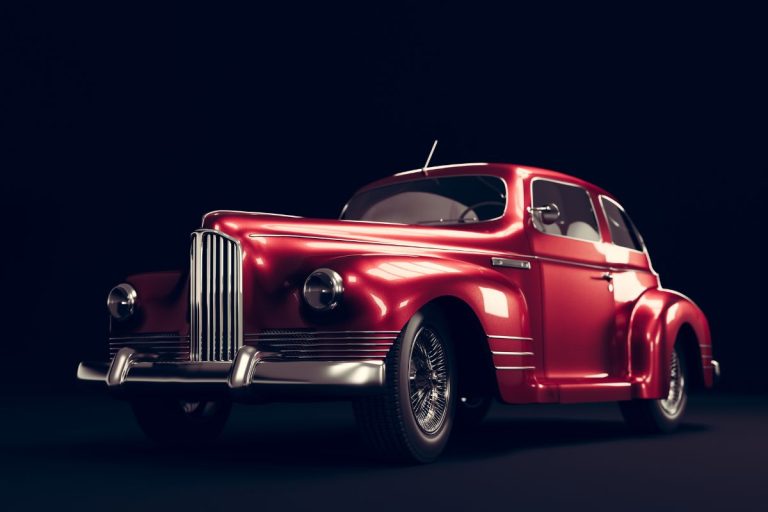 Close-up of a classic car being tuned up, showcasing its timeless design and meticulous maintenance